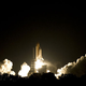 Illustration for article titled The Space Shuttle Blasts Into The Night